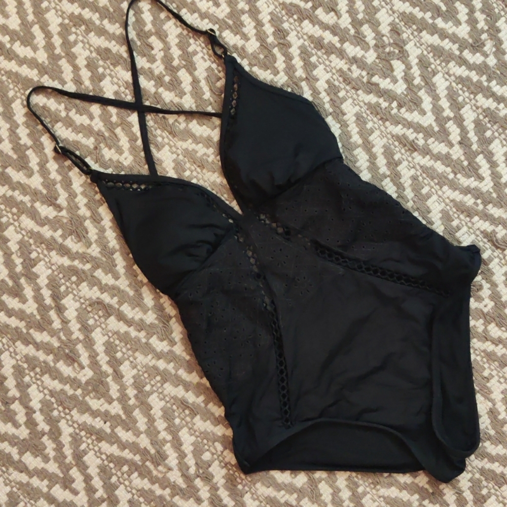 Black low-back swimsuit with eyelet details